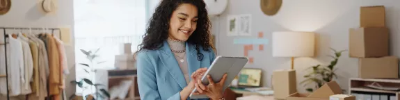 Business woman using a tablet in a small business logistics centre